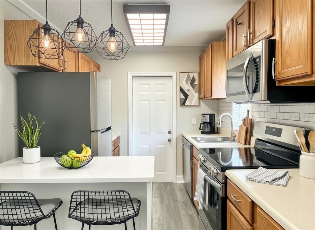 5045 Green Key Road New Port Richey, FL 34652 - Photo 7 of 32 a kitchen with a sink appliances and cabinets