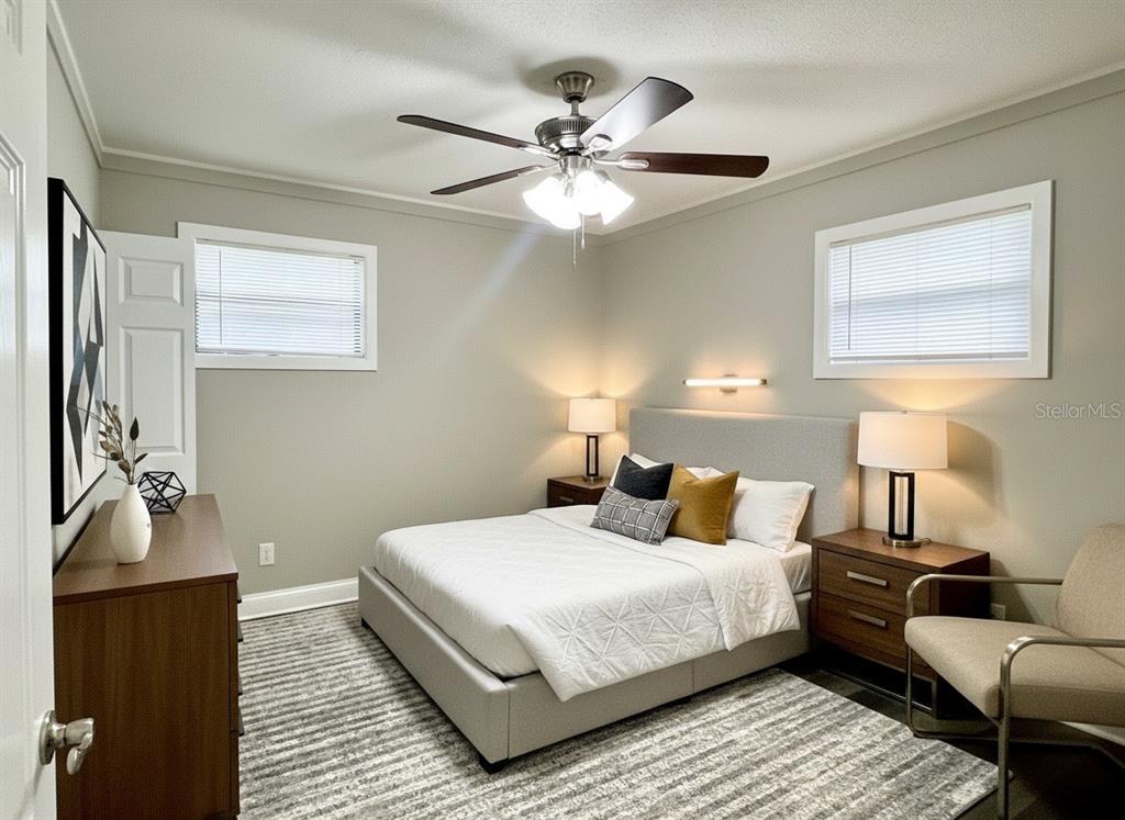 5045 Green Key Road New Port Richey, FL 34652 - Photo 8 of 32 a bedroom with a bed and wooden floor