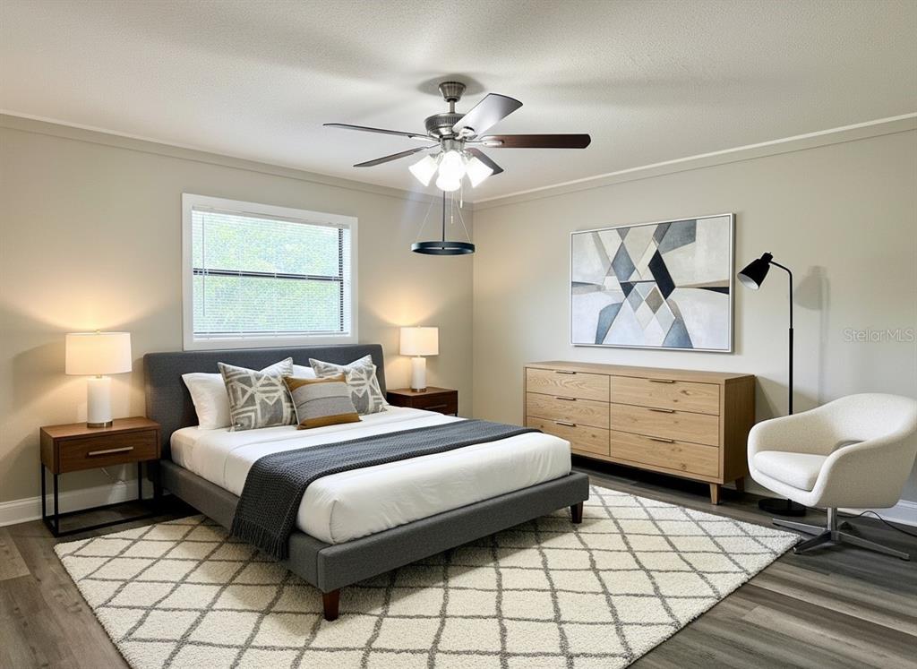 5045 Green Key Road New Port Richey, FL 34652 - Photo 9 of 32 a bedroom with a bed and a chandelier