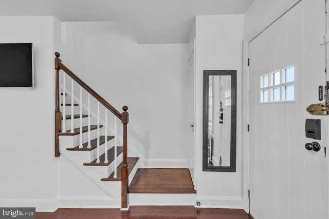 a view of entryway with stairs and wooden floor