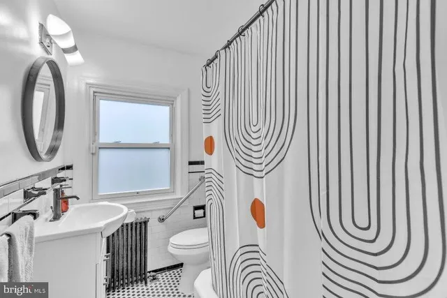 a bathroom with a sink a mirror and a window