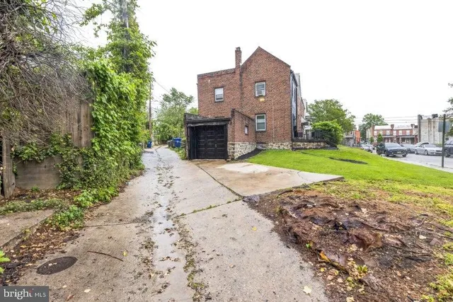 a view of a house with a yard and pathway
