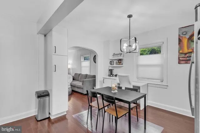 a view of a dining room with furniture wooden floor and chandelier