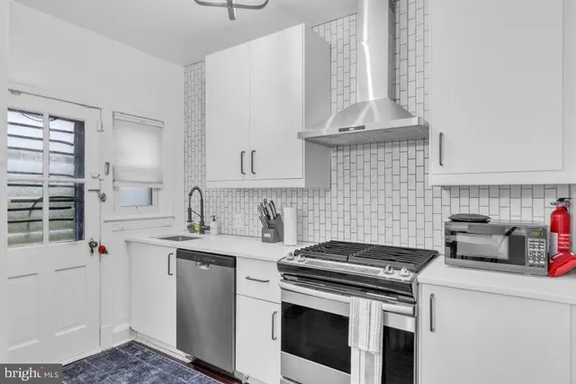 a kitchen with a stove and a sink