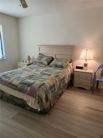 a bedroom with a bed and a lamp