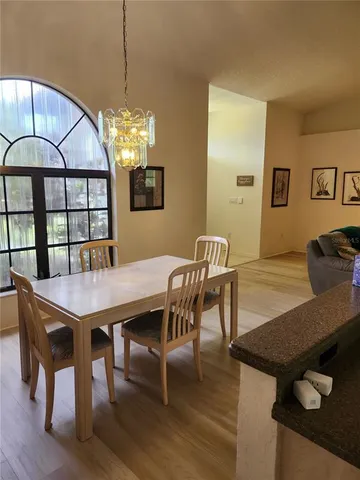 a view of a dining room with furniture and chandelier