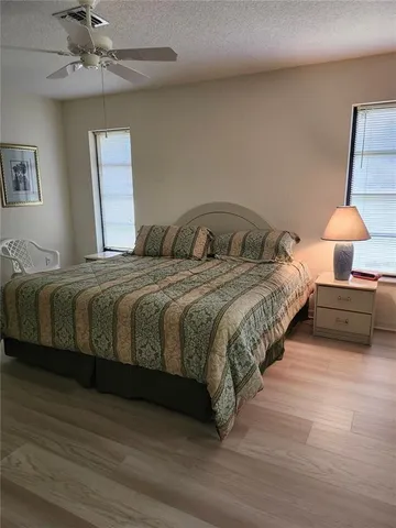 a bedroom with a bed and a lamp