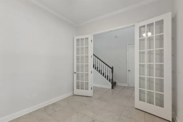 a view of a hallway with wooden floor and entryway