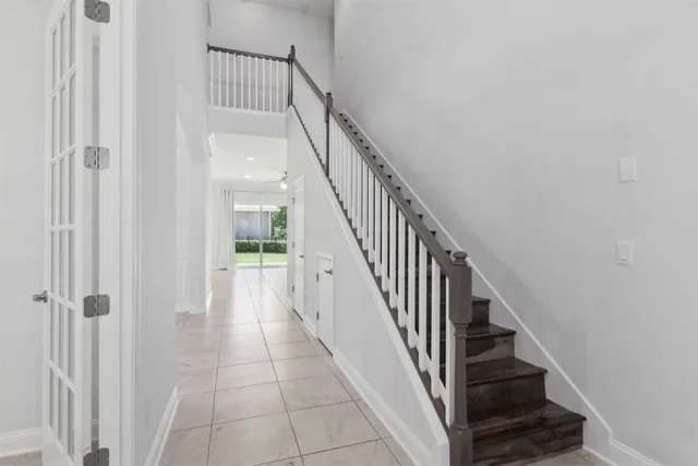 an empty room with windows and entryway