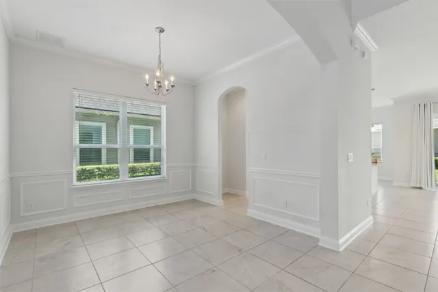 a view of an empty room with a chandelier
