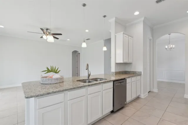 a kitchen with granite countertop a stove a sink and a counter space