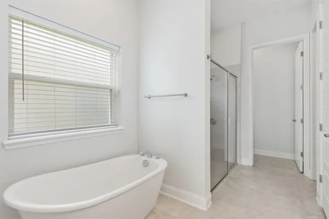 a bathroom with a shower and a glass door