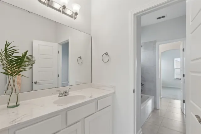 a bathroom with a double vanity sink and a mirror