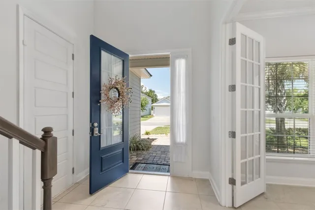 a view of entryway with tub and door
