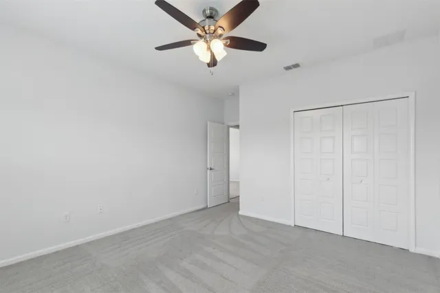 a bathroom with a sink toilet double vanity and shower