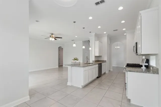 a kitchen with stainless steel appliances granite countertop a sink and cabinets