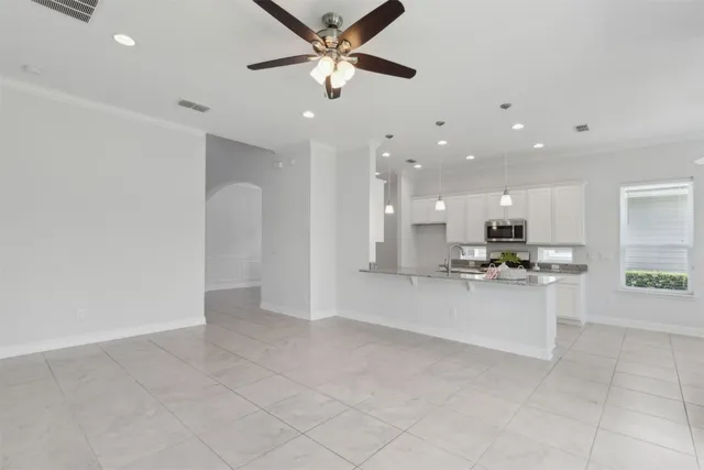 a view of a kitchen with a sink stainless steel appliances and cabinets
