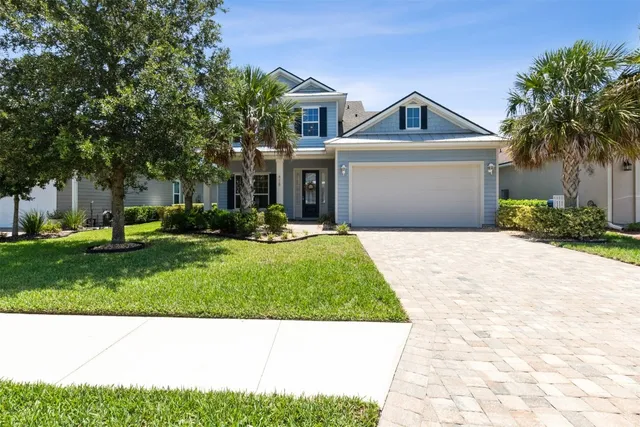 a front view of house with yard and green space