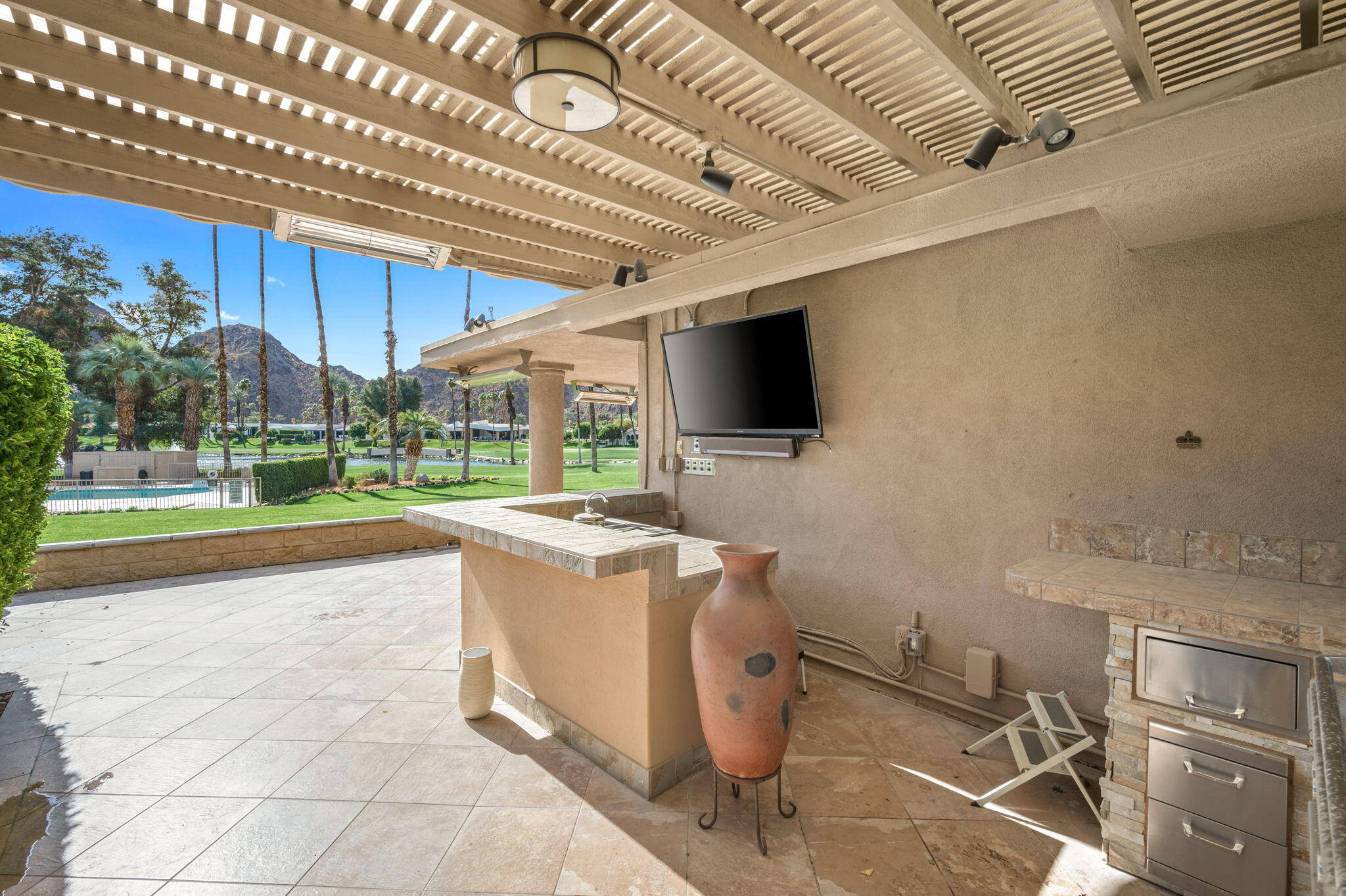 77675 Seminole Road Indian Wells, CA 92210 - Photo 17 of 40 a living room with a couch and a flat screen tv