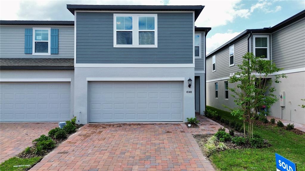 4348 Ranch House Road St. Cloud, FL 34772 - Photo 1 of 58 a front view of house with yard and trees around