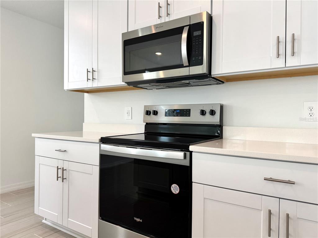 4348 Ranch House Road St. Cloud, FL 34772 - Photo 17 of 58 a kitchen with stainless steel appliances granite countertop a stove and a microwave