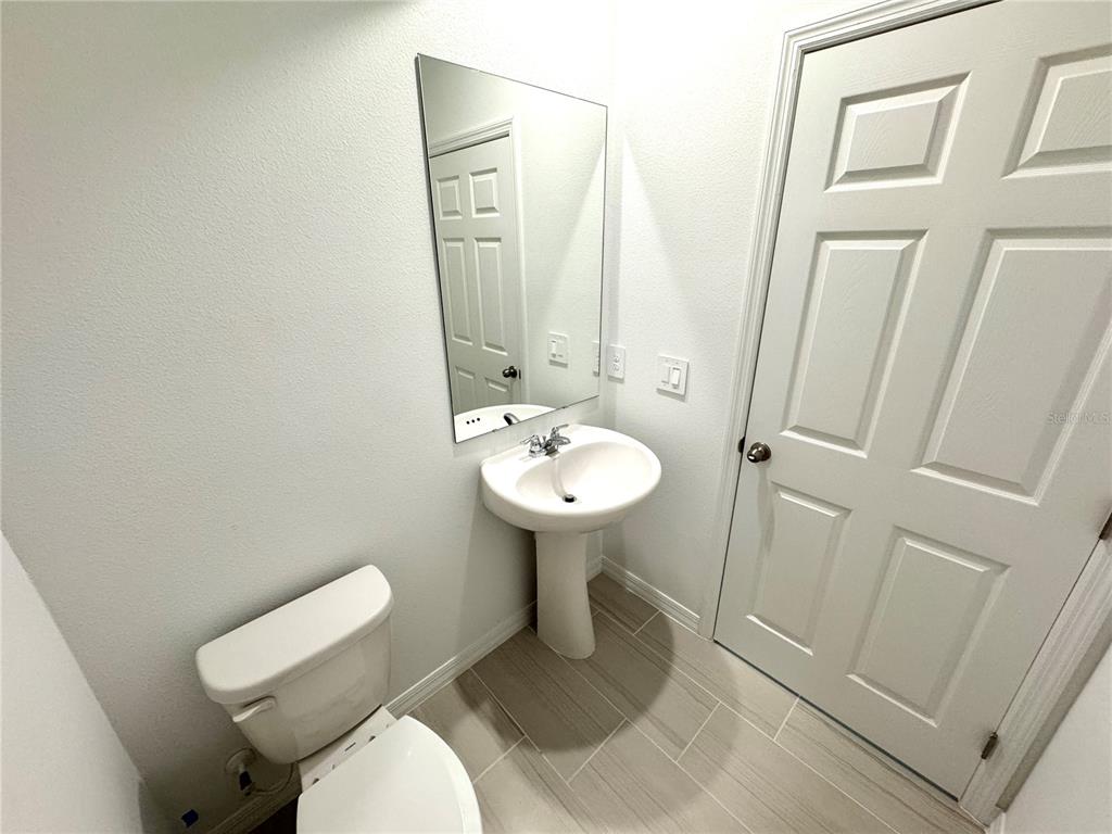 4348 Ranch House Road St. Cloud, FL 34772 - Photo 19 of 58 a bathroom with a sink toilet and a mirror