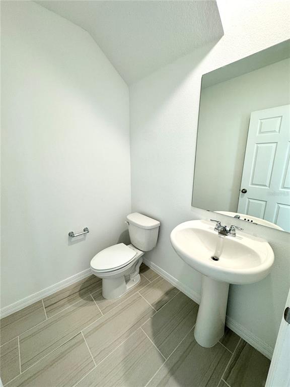 4348 Ranch House Road St. Cloud, FL 34772 - Photo 20 of 58 a white toilet sitting next to a bathroom sink
