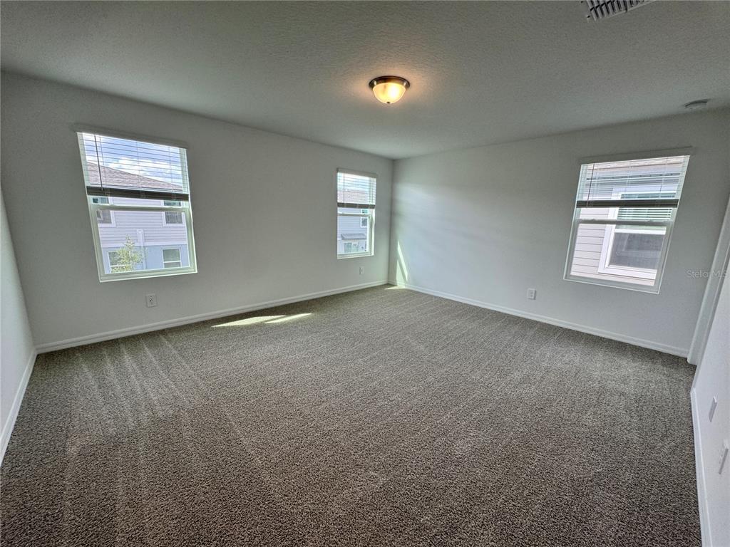 4348 Ranch House Road St. Cloud, FL 34772 - Photo 22 of 58 an empty room with windows