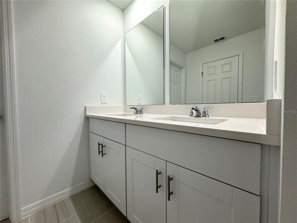 4348 Ranch House Road St. Cloud, FL 34772 - Photo 24 of 58 a bathroom with a sink and a mirror