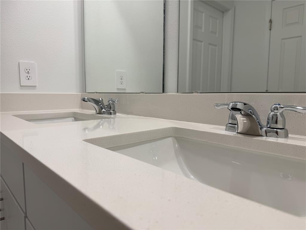 4348 Ranch House Road St. Cloud, FL 34772 - Photo 25 of 58 a bathroom with a sink and a mirror