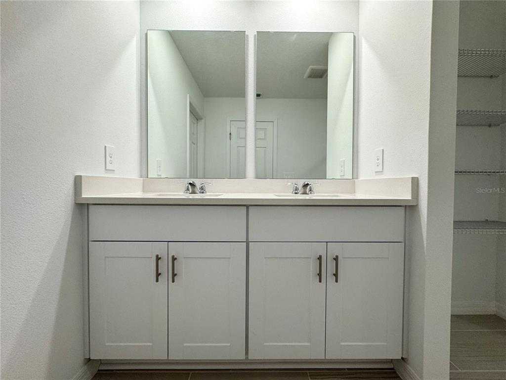 4348 Ranch House Road St. Cloud, FL 34772 - Photo 26 of 58 a bathroom with a sink and a mirror