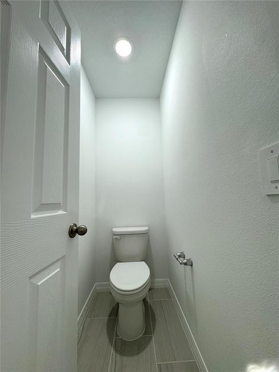 4348 Ranch House Road St. Cloud, FL 34772 - Photo 27 of 58 a white toilet sitting next to a shower