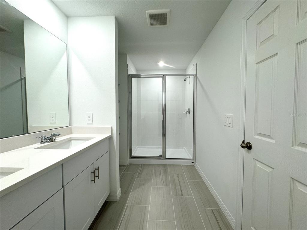 4348 Ranch House Road St. Cloud, FL 34772 - Photo 28 of 58 a bathroom with a double vanity sink and mirror