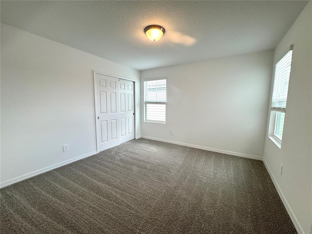 4348 Ranch House Road St. Cloud, FL 34772 - Photo 30 of 58 a view of an empty room with a window and wooden floor