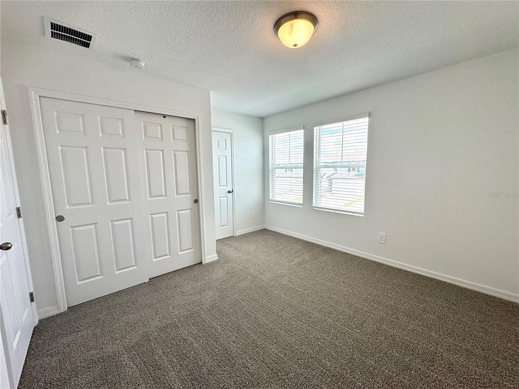 4348 Ranch House Road St. Cloud, FL 34772 - Photo 36 of 58 an empty room with windows