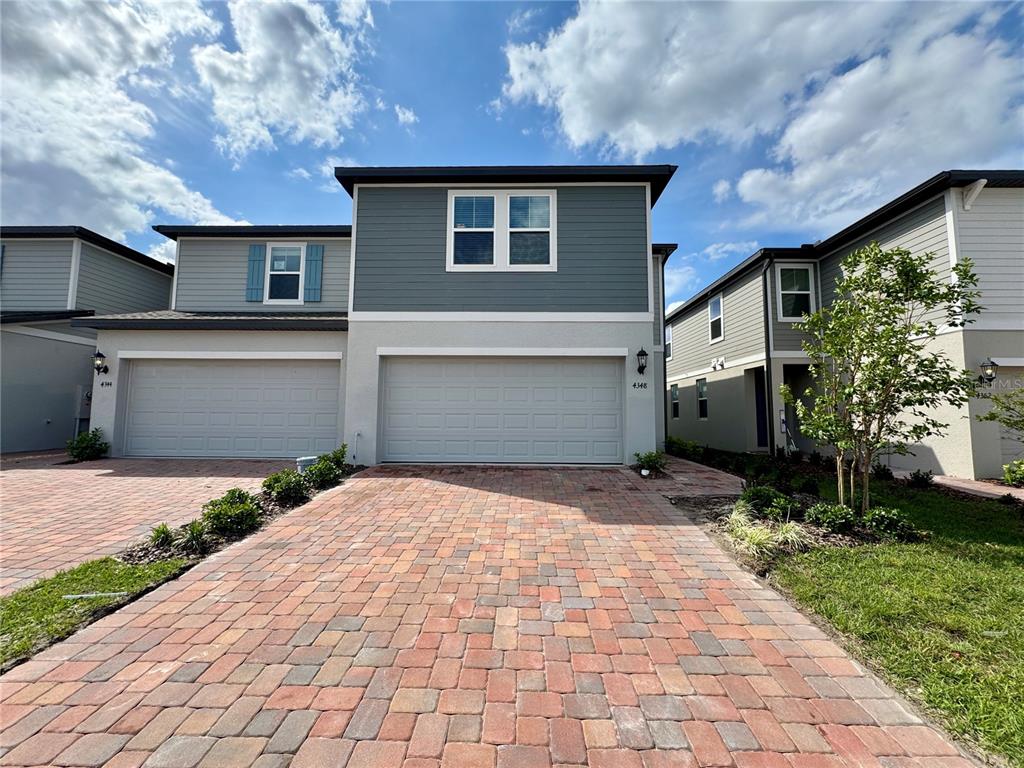 4348 Ranch House Road St. Cloud, FL 34772 - Photo 46 of 58 a front view of a house with garden
