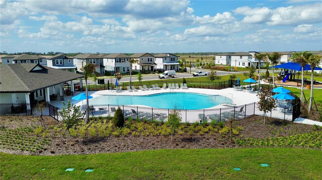 4348 Ranch House Road St. Cloud, FL 34772 - Photo 52 of 58 a view of a swimming pool with lawn chairs and a fire pit