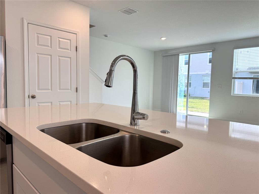 4348 Ranch House Road St. Cloud, FL 34772 - Photo 6 of 58 a kitchen with a sink and a large window