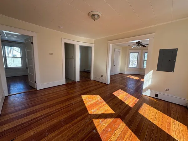 an entryway with wooden floor and furniture