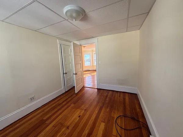 a view of a room with wooden floor and white walls