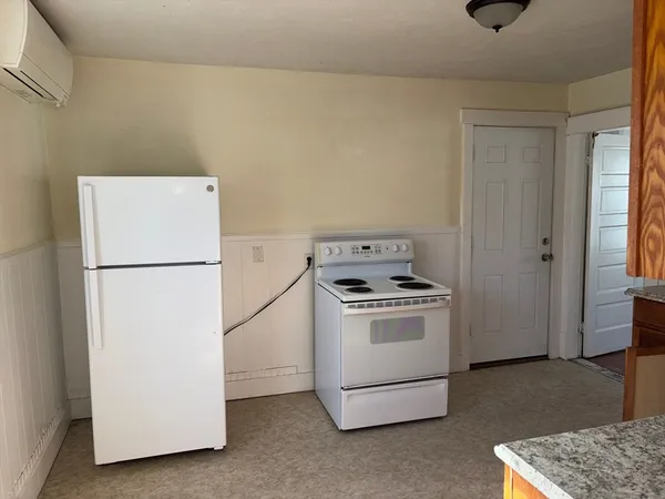 a kitchen with a refrigerator a stove a washer and dryer