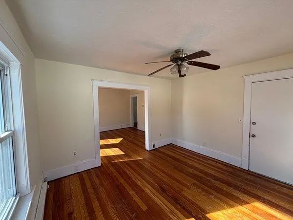 wooden floor in an empty room with a window