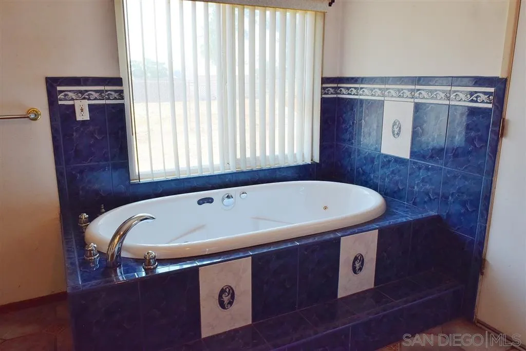 1852 Lilac Road Ramona, CA 92065 - Photo 15 of 25 a bath tub sitting in a bathroom next to a window