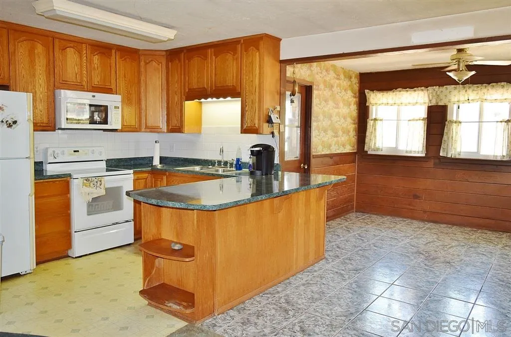 1852 Lilac Road Ramona, CA 92065 - Photo 3 of 25 a kitchen with stainless steel appliances granite countertop a sink stove and cabinets