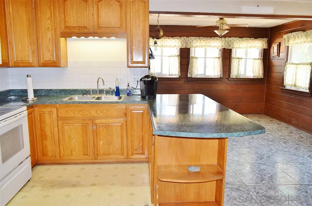1852 Lilac Road Ramona, CA 92065 - Photo 5 of 25 a view of a kitchen with a sink and a window