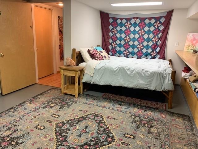22810 Nelson Road Bend, OR 97701 - Photo 16 of 43 a bedroom with a bed and wooden floor