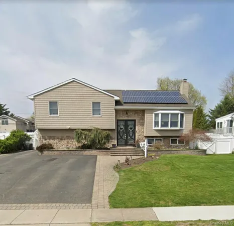 a view of house with a yard