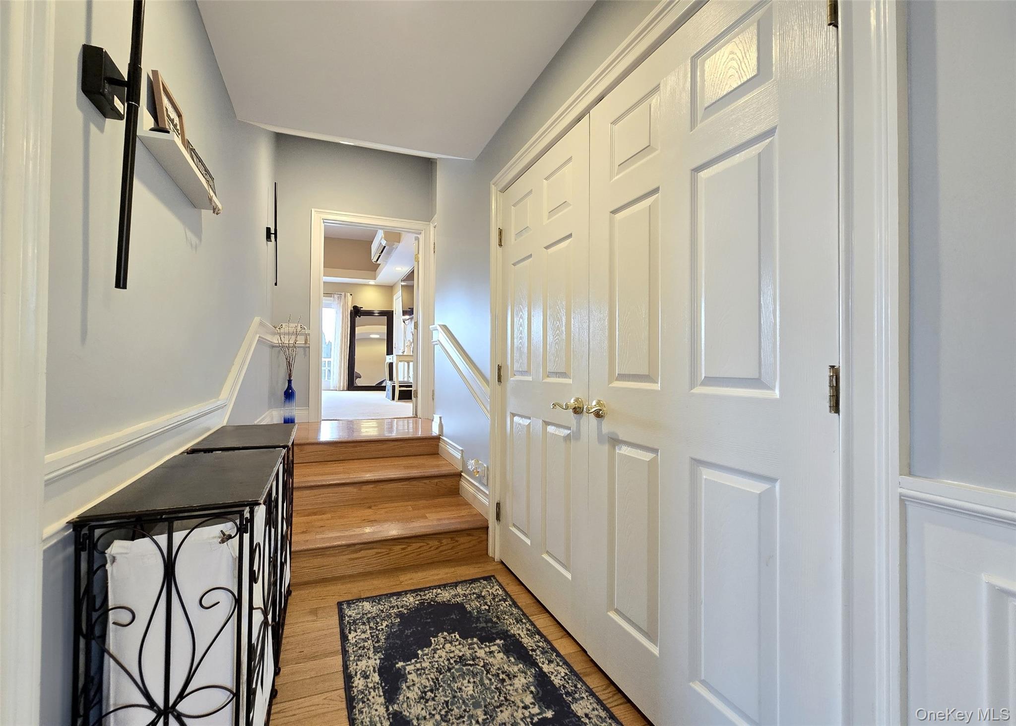 46 Harvest Lane Commack, NY 11725 - Photo 15 of 40 a view of a hallway with wooden floor and staircase