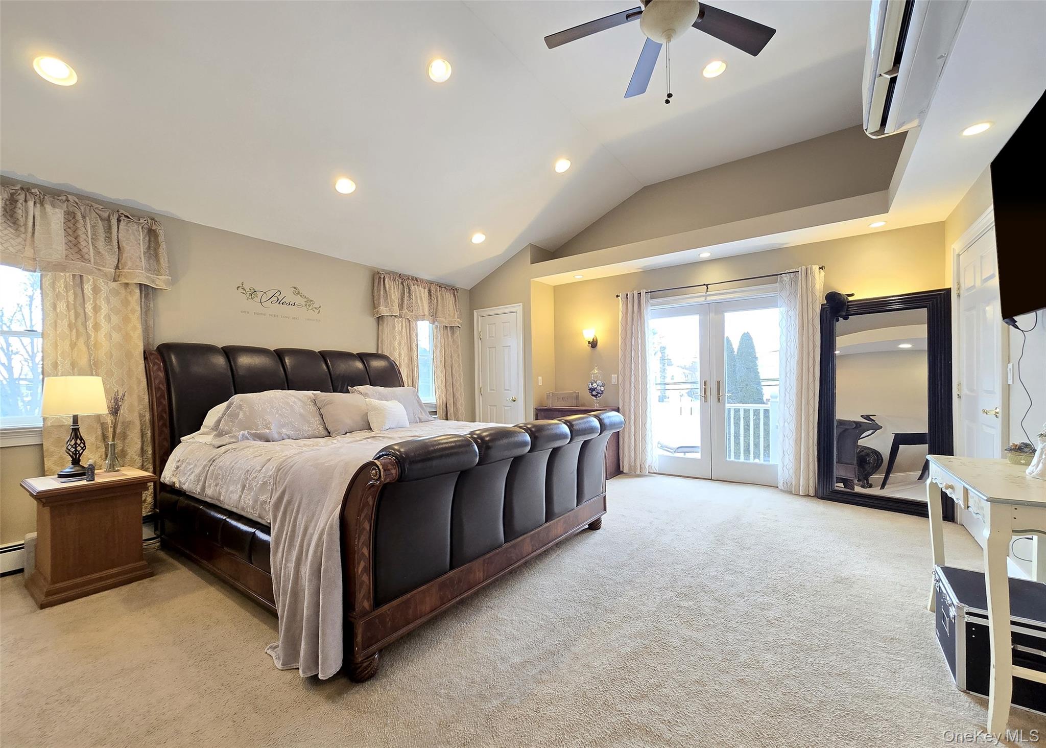 46 Harvest Lane Commack, NY 11725 - Photo 18 of 40 a spacious bedroom with a bed a couch and a chandelier