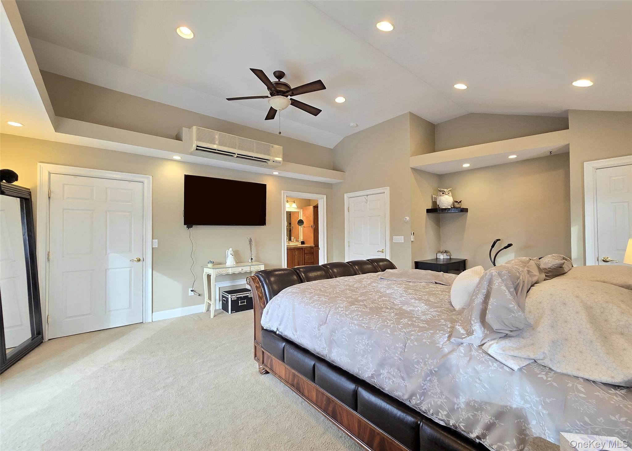 46 Harvest Lane Commack, NY 11725 - Photo 19 of 40 a spacious bedroom with a bed and a flat screen tv